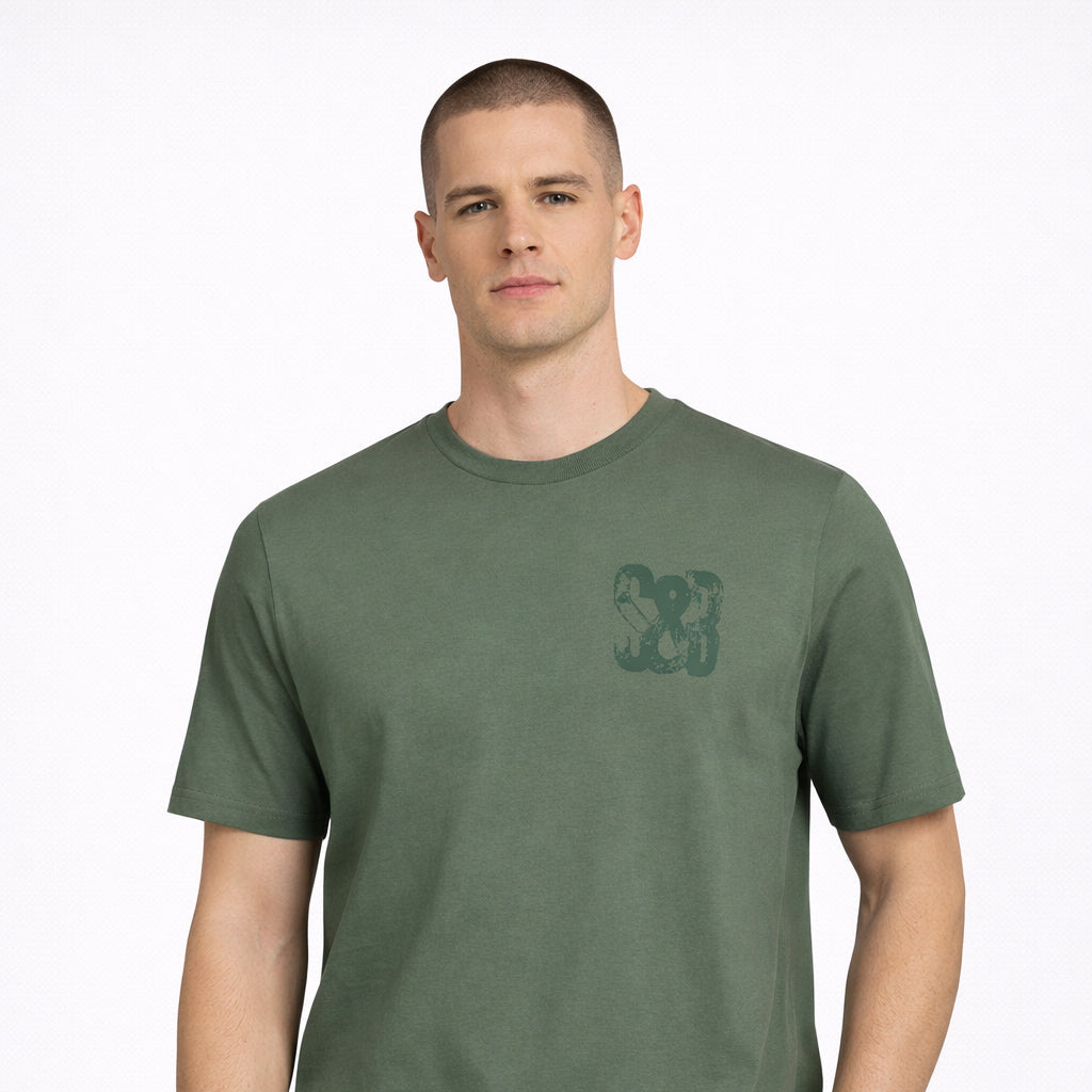 Green Bay T-Shirt in green with printed chest logo worn by model by Sauce & Brown