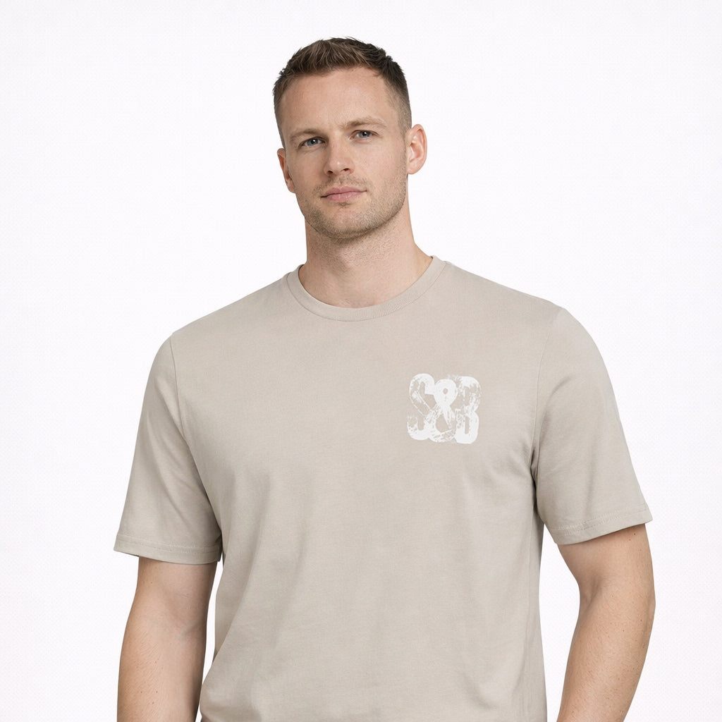 Stone Press Printed Tee in stone with chest logo worn by model by Sauce & Brown