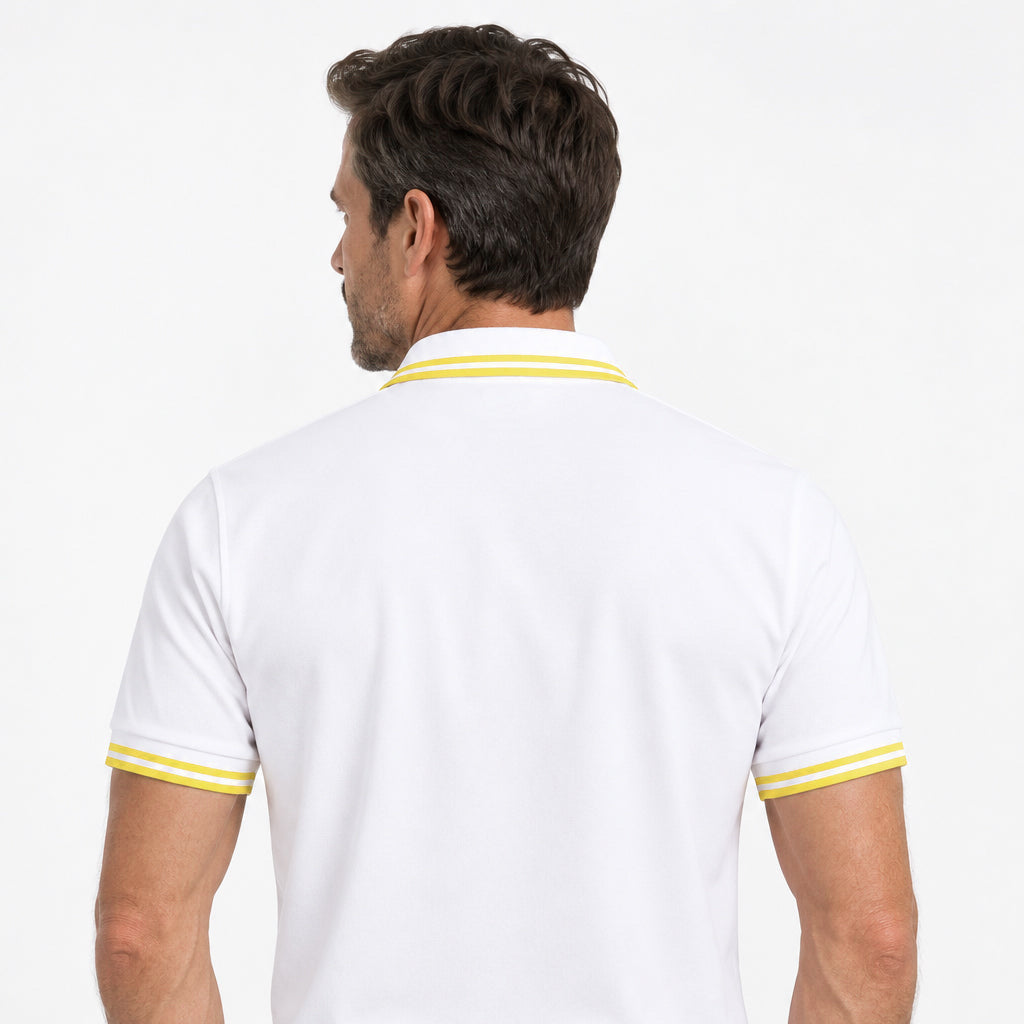 Rear view of model wearing the Sauce & Brown Capri white polo shirt with yellow collar and cuff trim.
