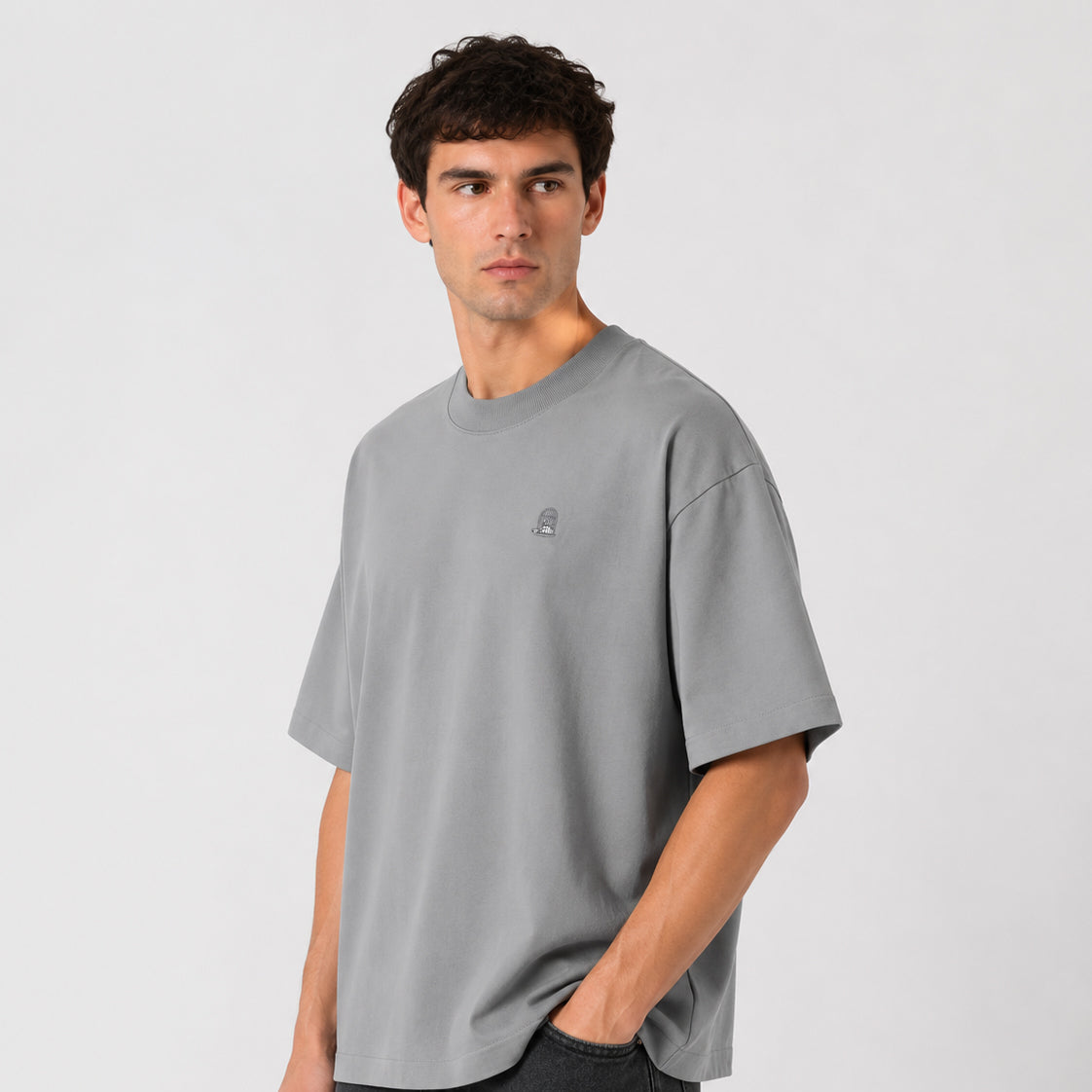 Sauce & Brown Haze oversized t-shirt in light grey worn by male model – three-quarter studio view