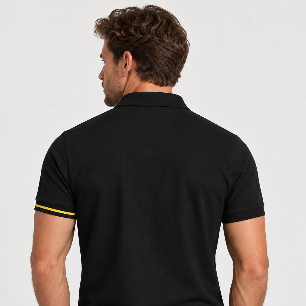 Rear view of model wearing the Sauce & Brown Offset black polo shirt with yellow cuff stripe.