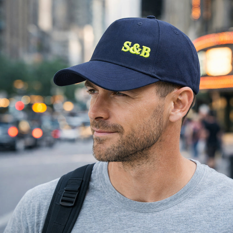 Model wearing Youth Cap in navy with yellow logo by Sauce & Brown