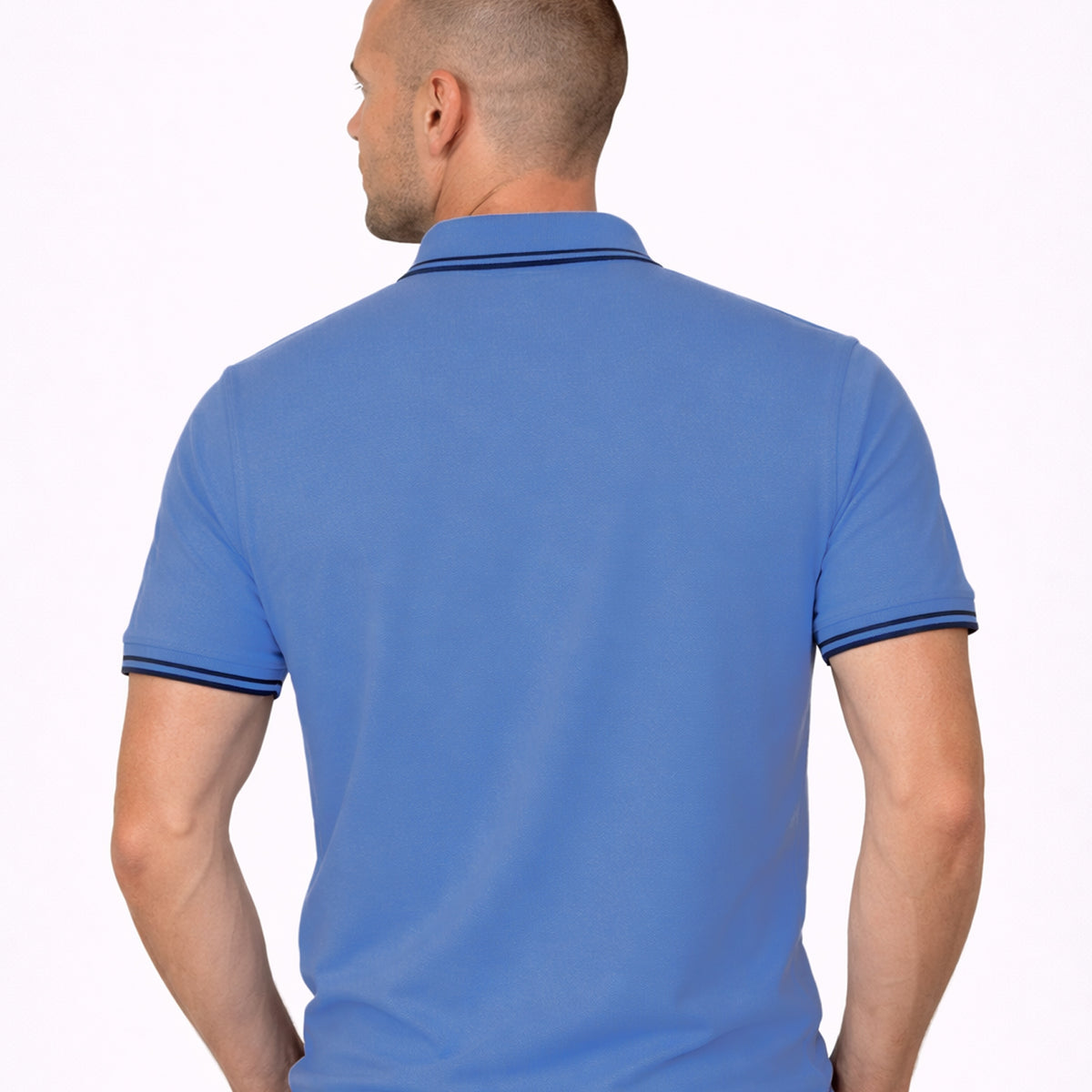 Male model wearing Mariner blue polo shirt with navy tipping, rear view